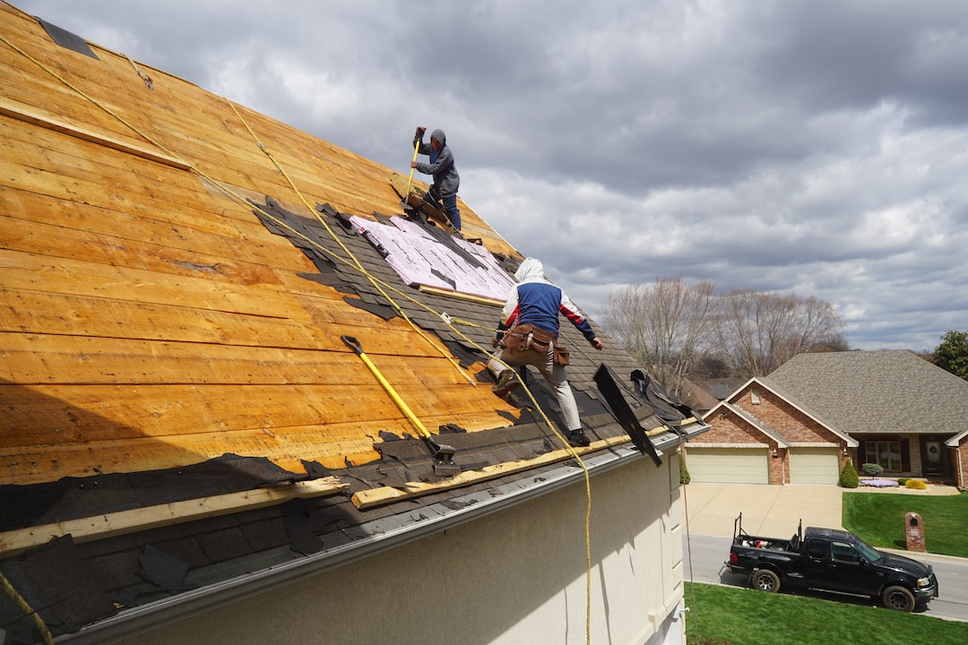 Roofer working on storm damage repairs