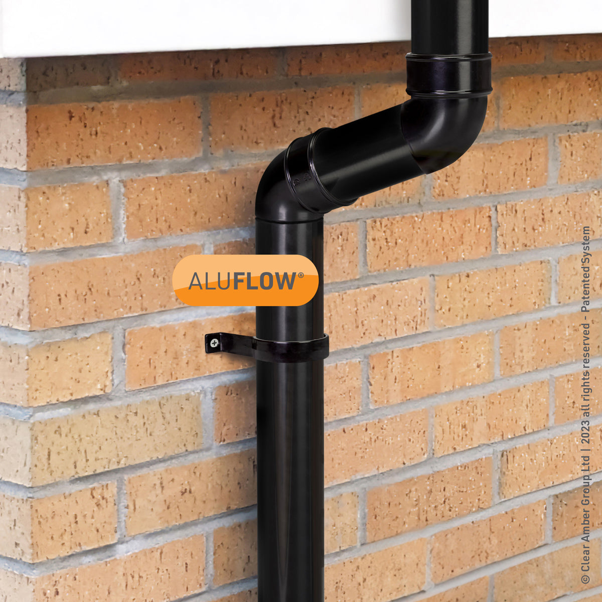 New downpipe installed against brick wall