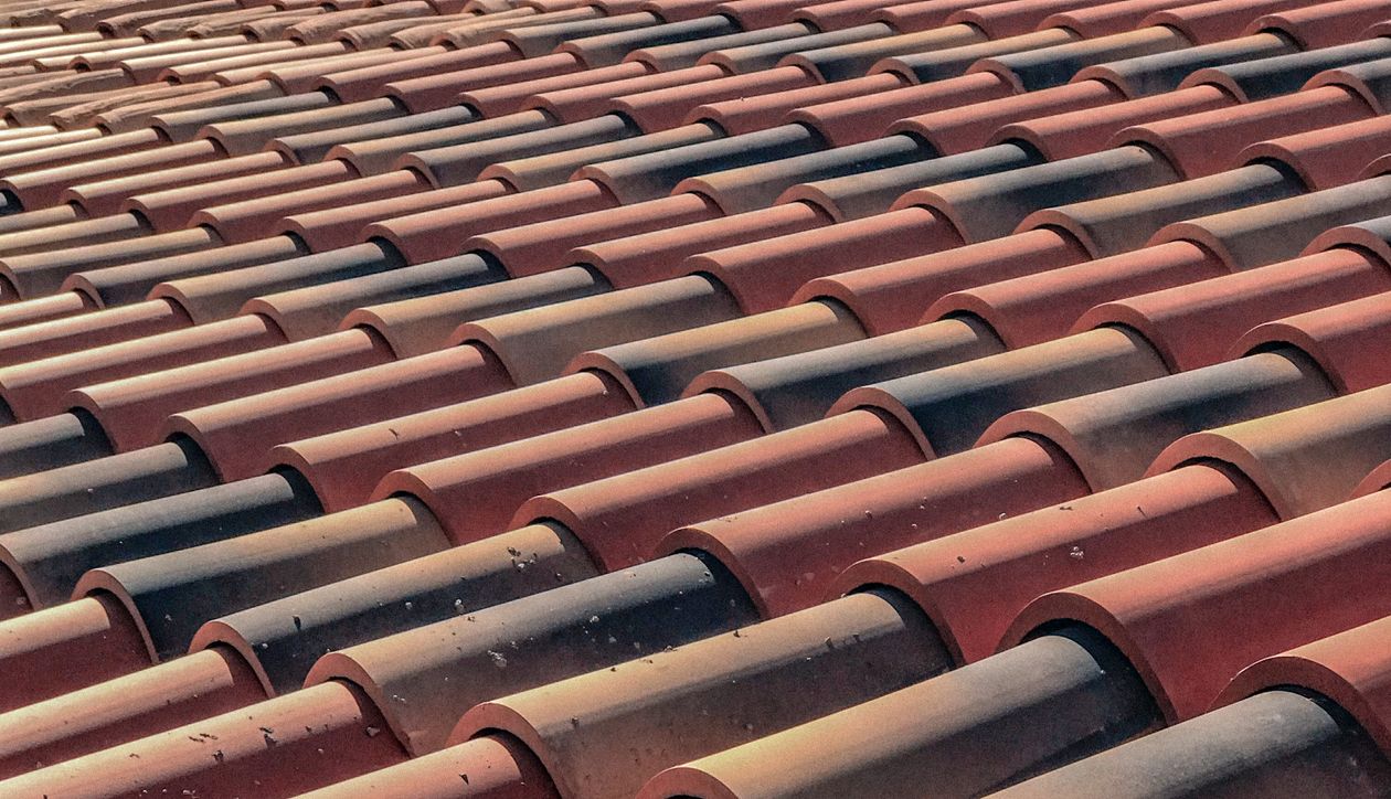 Close-up of clay roof tiles in overlapping pattern